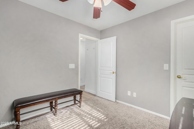 interior space with light carpet and ceiling fan