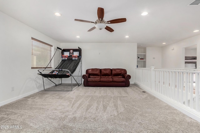 sitting room featuring ceiling fan and light colored carpet