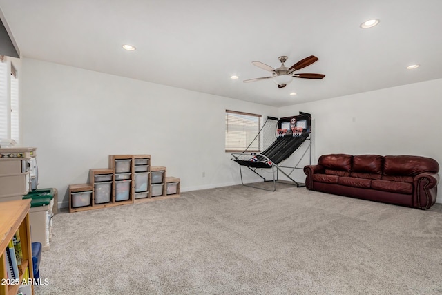 playroom with ceiling fan and light colored carpet