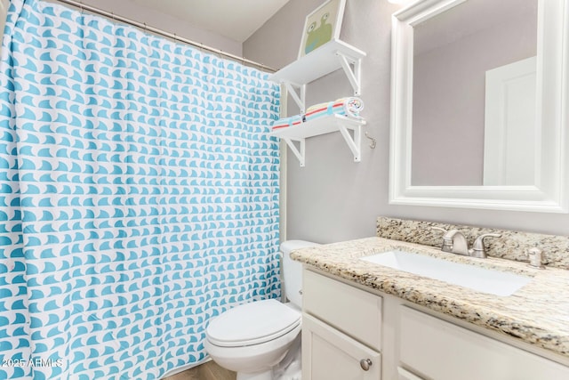 bathroom featuring vanity and toilet