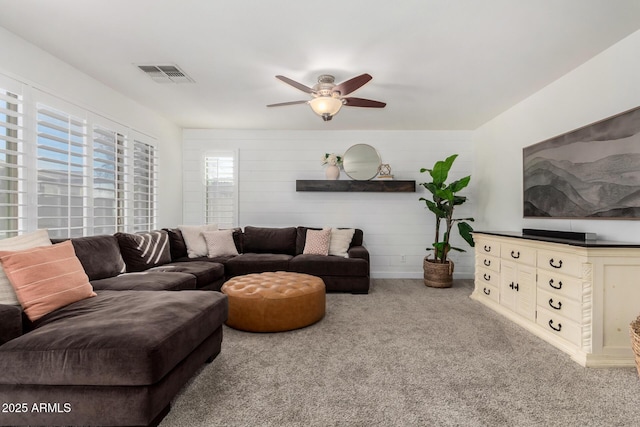 carpeted living room featuring ceiling fan