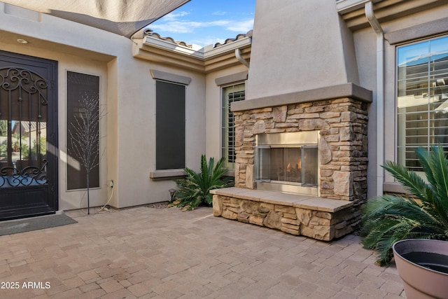 view of patio featuring an outdoor stone fireplace