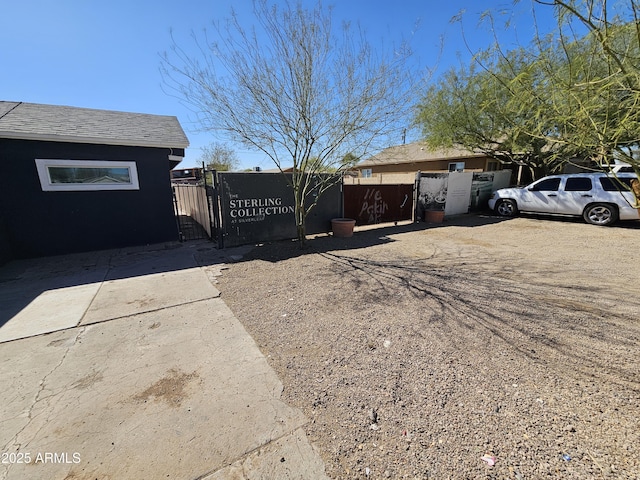 view of home's exterior featuring fence and a gate