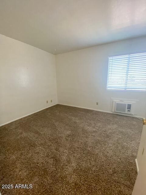 unfurnished room featuring carpet and a wall mounted AC