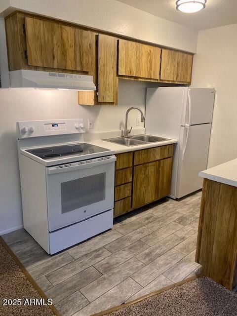 kitchen featuring white appliances and sink