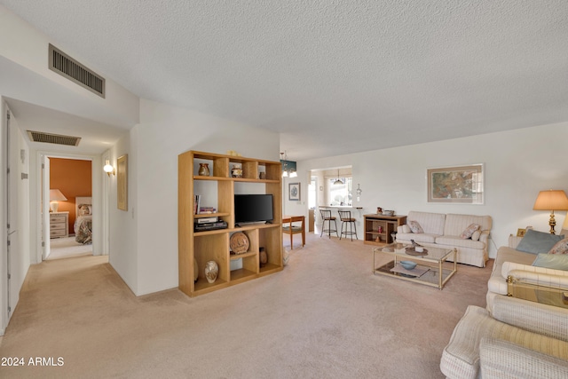 carpeted living room featuring a textured ceiling