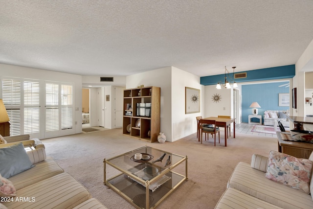 living room featuring light colored carpet and a textured ceiling