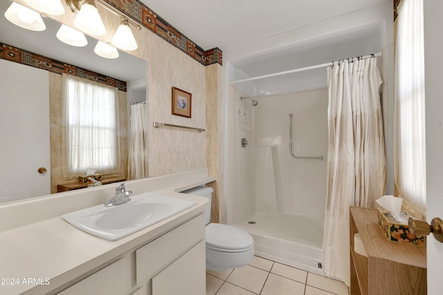 bathroom with toilet, vanity, tile patterned floors, and a shower with shower curtain