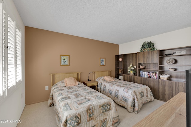 carpeted bedroom with a textured ceiling