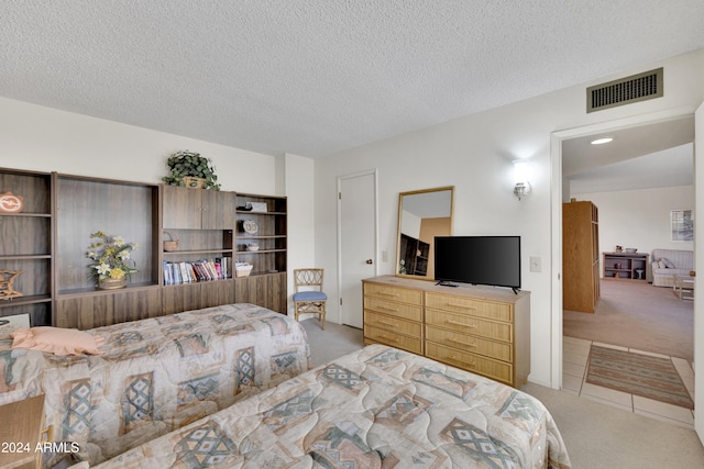 carpeted bedroom with a textured ceiling