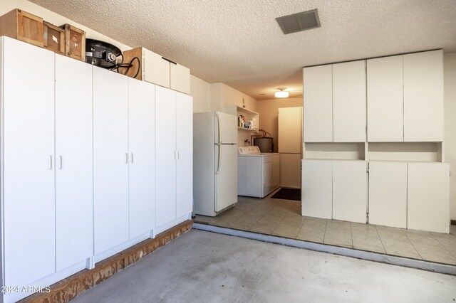 garage featuring white fridge and washer / clothes dryer