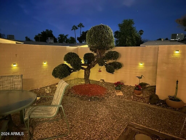 yard at night with a patio