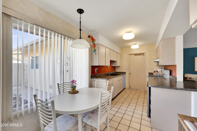 kitchen featuring white cabinets, stainless steel electric range, pendant lighting, and sink