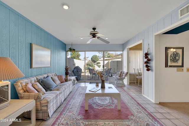 tiled living room with ceiling fan