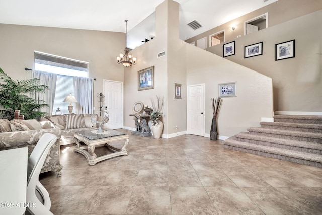 living room featuring an inviting chandelier, tile patterned flooring, and a high ceiling