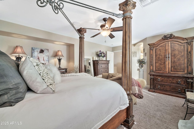 carpeted bedroom featuring ceiling fan and ornate columns