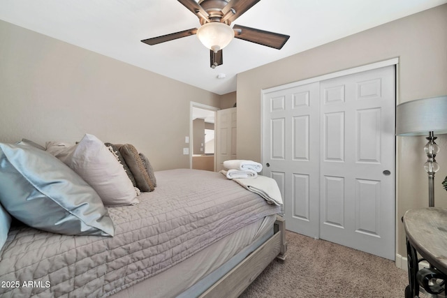 carpeted bedroom featuring ceiling fan and a closet