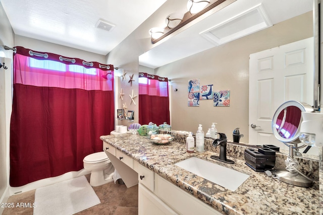 bathroom with vanity, toilet, and walk in shower