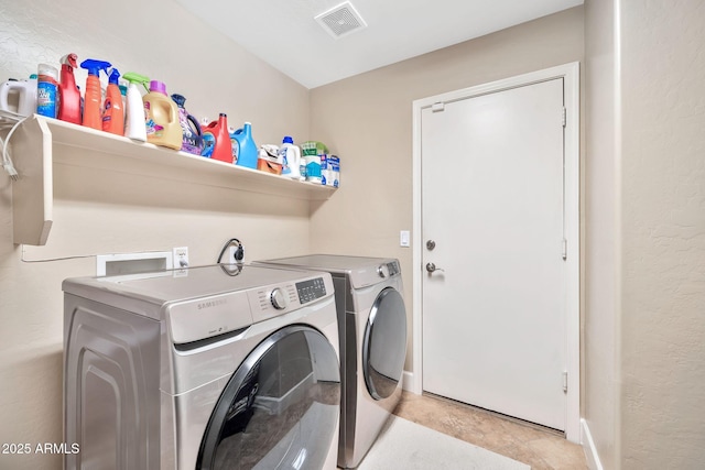 laundry area with independent washer and dryer