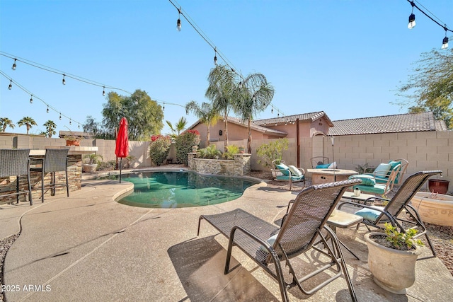 view of pool with exterior bar and a patio area