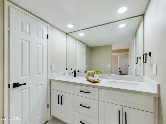 bathroom featuring double vanity and recessed lighting