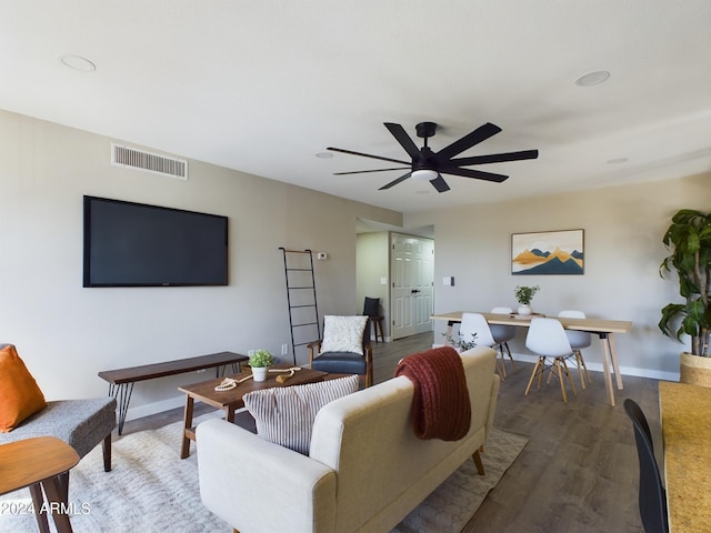 living area with ceiling fan, baseboards, and wood finished floors