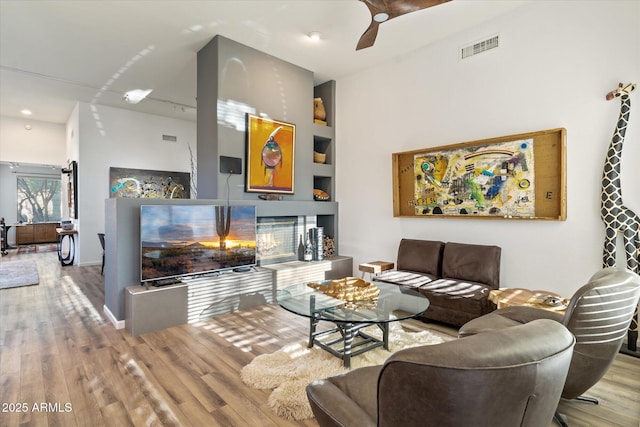 living room with ceiling fan and light hardwood / wood-style floors