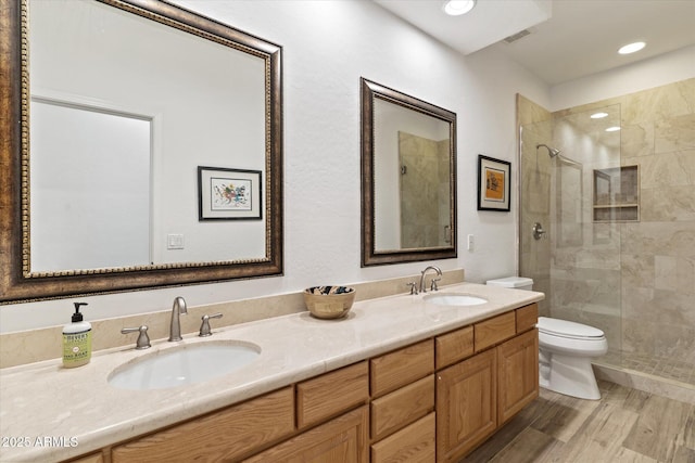 bathroom featuring walk in shower, toilet, vanity, and hardwood / wood-style flooring