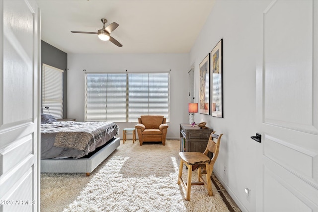 bedroom with ceiling fan and light colored carpet