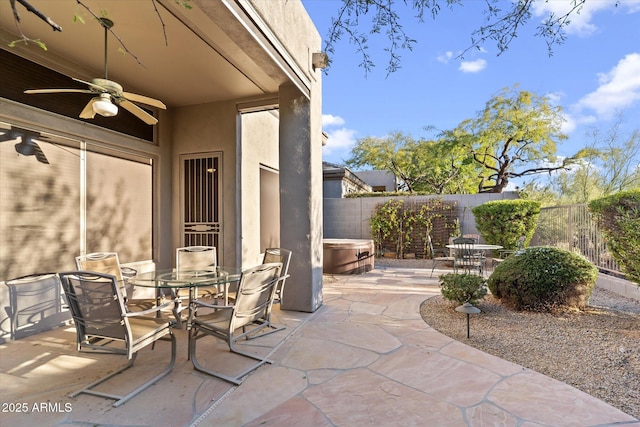 view of patio with a hot tub and ceiling fan