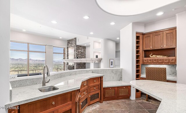 bathroom featuring a fireplace, tile patterned floors, built in features, tasteful backsplash, and sink