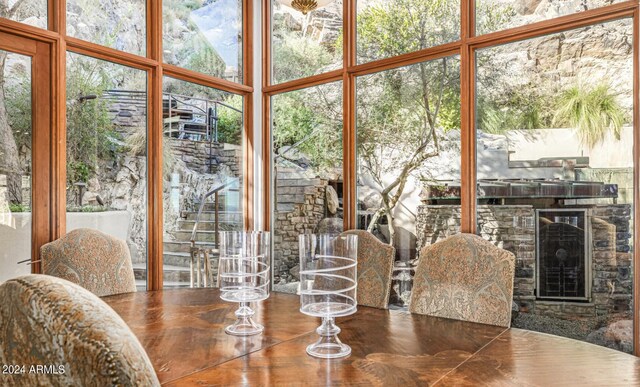 dining room featuring floor to ceiling windows, a healthy amount of sunlight, and a towering ceiling