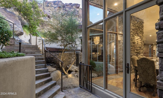 exterior space featuring stairway and a wall of windows