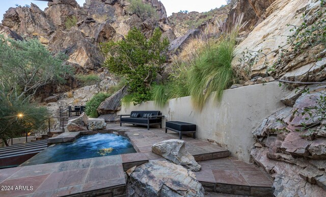 view of pool featuring a patio and a mountain view