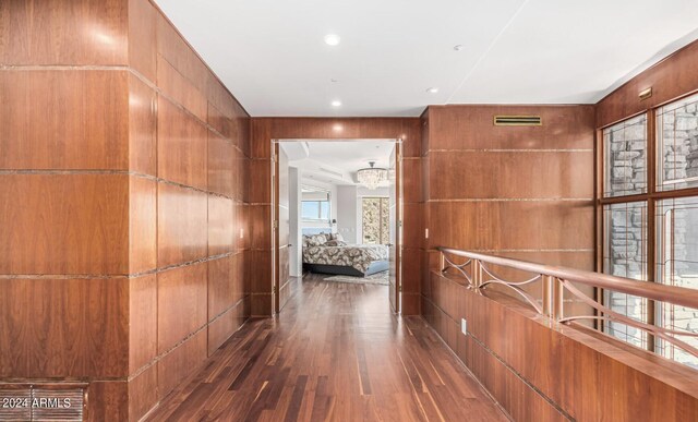 corridor with dark wood-type flooring and plenty of natural light