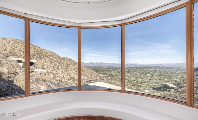 unfurnished sunroom with a mountain view