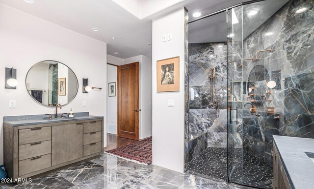 bathroom with an enclosed shower, vanity, and tile patterned flooring