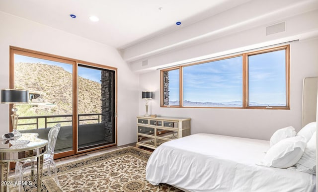 bedroom with a mountain view, recessed lighting, visible vents, and access to exterior