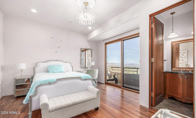 bedroom featuring recessed lighting, a notable chandelier, a sink, wood finished floors, and access to outside