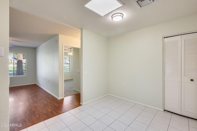 14300 W Bell Rd Unit 35, Surprise, AZ 85374 - spare room with light tile patterned floors, a textured ceiling, baseboards, and visible vents