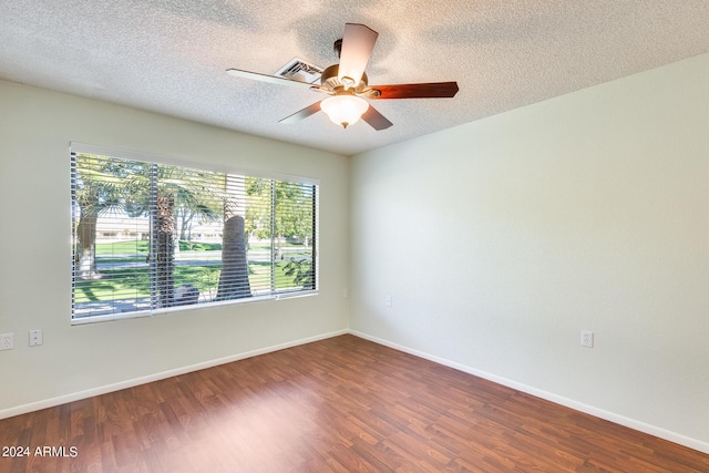 14300 W Bell Rd Unit 35, Surprise, AZ 85374 - unfurnished room featuring dark wood finished floors, baseboards, a textured ceiling, and a ceiling fan