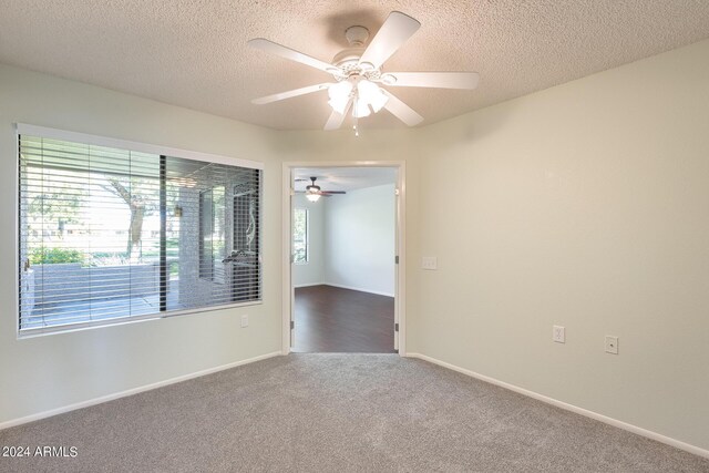 14300 W Bell Rd Unit 35, Surprise, AZ 85374 - empty room with a healthy amount of sunlight, a textured ceiling, carpet flooring, and a ceiling fan