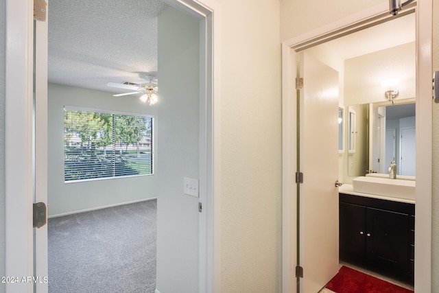 14300 W Bell Rd Unit 35, Surprise, AZ 85374 - bathroom featuring a ceiling fan, vanity, baseboards, and a textured ceiling