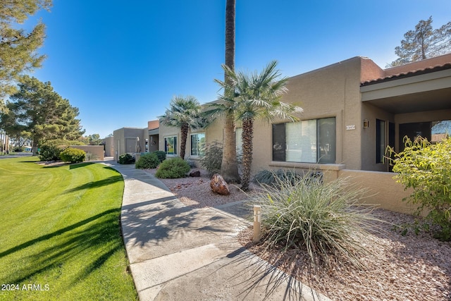 14300 W Bell Rd Unit 35, Surprise, AZ 85374 - view of front of property with a front lawn, stucco siding, and a tiled roof