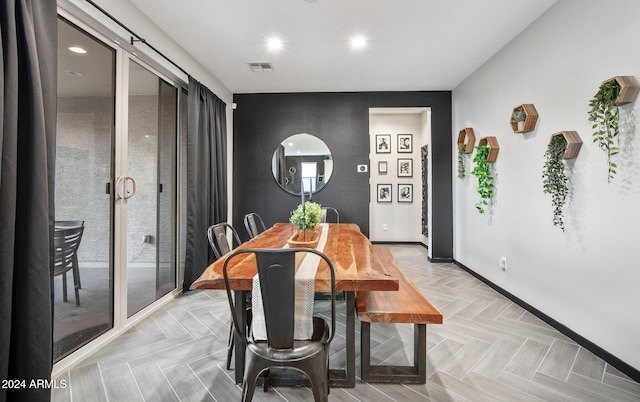 dining space featuring light parquet floors