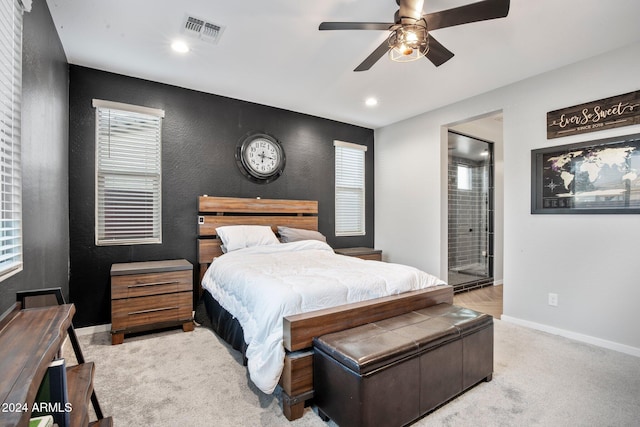 carpeted bedroom featuring connected bathroom and ceiling fan