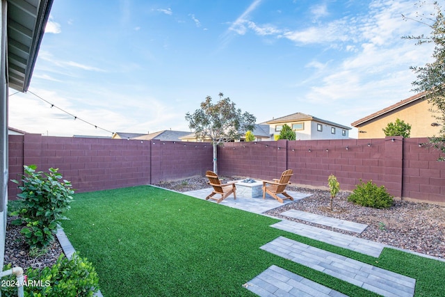 view of yard with a fire pit and a patio area