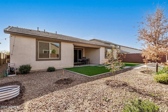 rear view of property with a lawn and a patio area