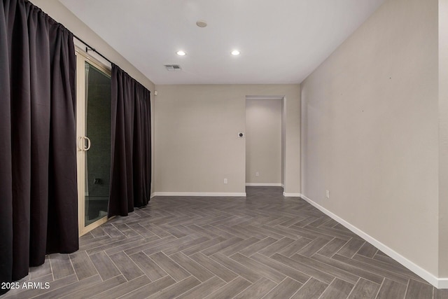 spare room featuring dark parquet flooring