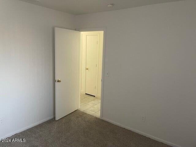 spare room with light colored carpet